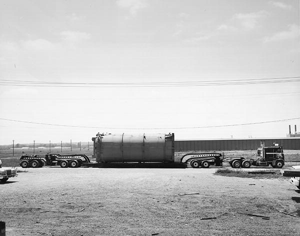 A pressure vessel on a Cozad trailer with nine axles.